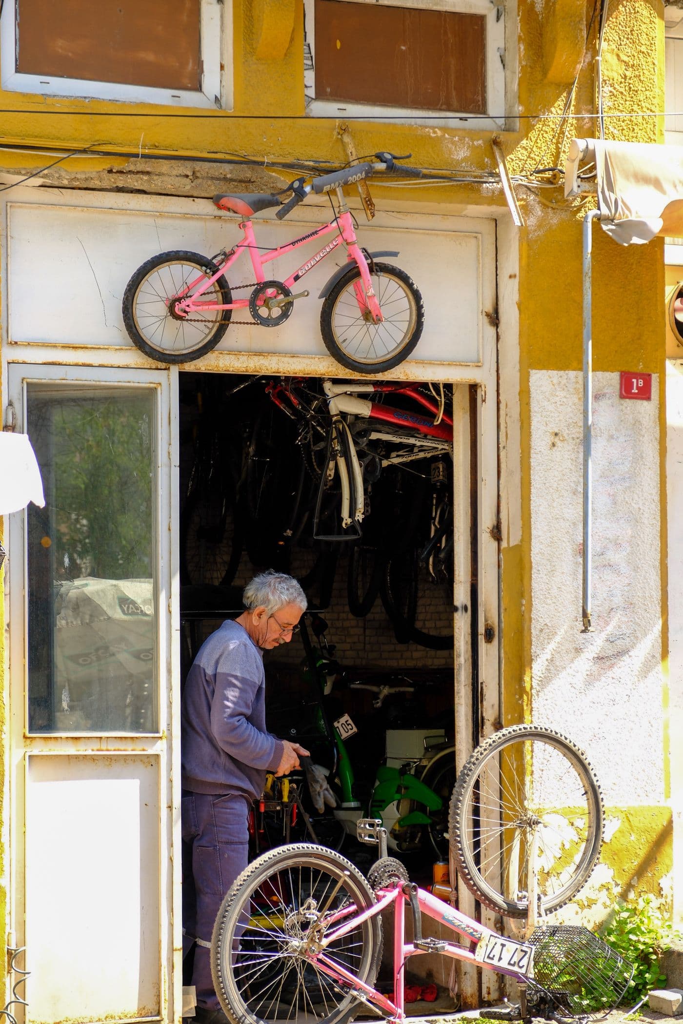A mechanic repairing a bicycle in his workshop